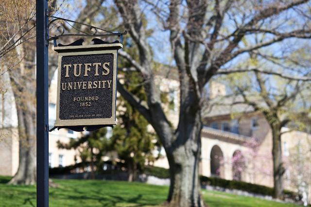 Tufts University sign in front of a tree